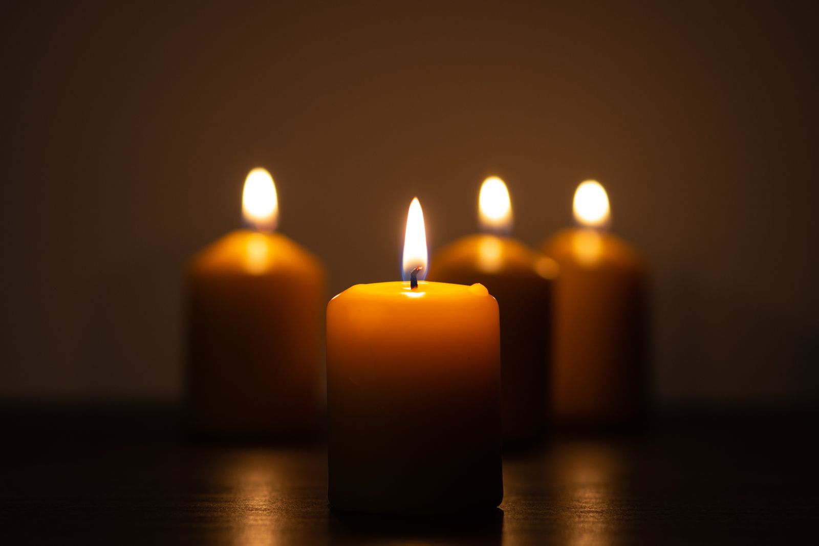 Candles glowing in a darkened treatment room